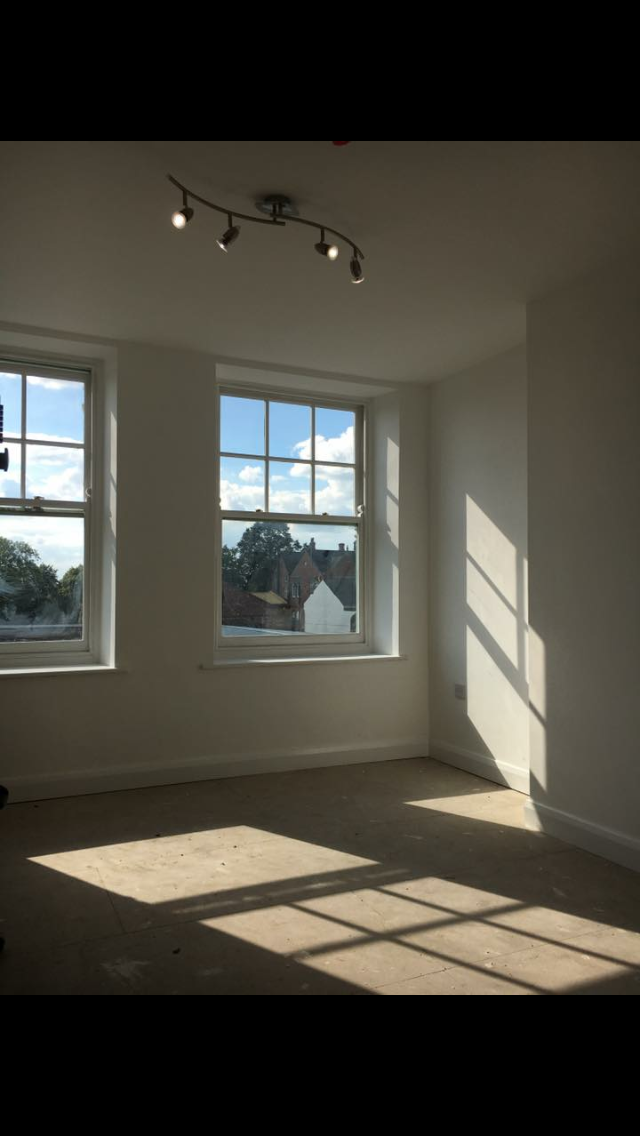 Bright empty office with sash windows and natural light
